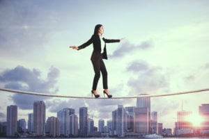 Business woman on a tightrope