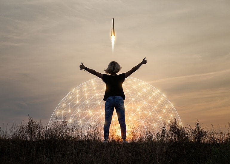 Person celebrating rocket take-off to express startup success