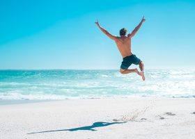 jumping for joy on beach