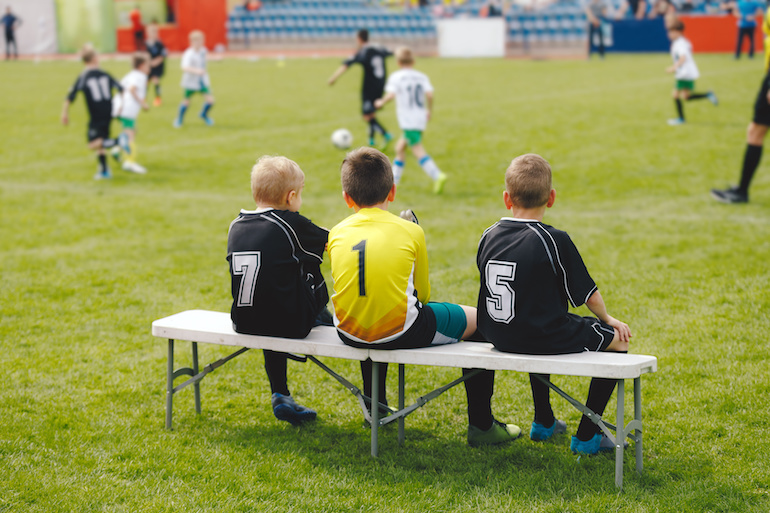 Kids sports subsitutes on sidelines